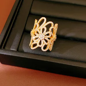 Detailed macro view of 18K gold plated open flower ring set with brilliant zirconia stones