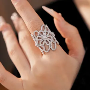 Elegant close-up of a 18K gold plated zircon hollow flower open ring worn on a finger