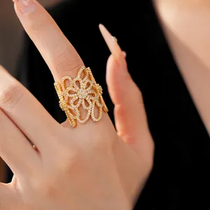 Close-up of an exquisite 18K gold plated hollow flower ring with pavé zircon detailing