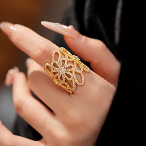 Detailed macro view of an 18K gold plated hollow flower open ring with zircon inlays