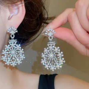 Detail view of elegant snowflake pearl zircon earrings showing intricate craftsmanship