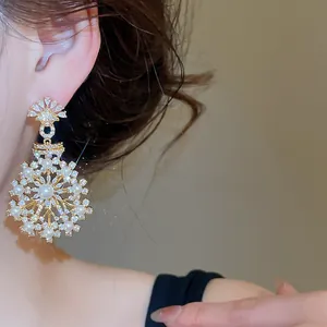 Detailed view of French vintage snowflake earrings with sparkling zircons and pearls