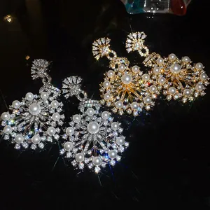 Detailed close-up of French vintage court-style snowflake earrings with pearls and zircons