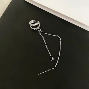 Close-up of double-layer silver ear cuff with sparkling zircon and long chain threader