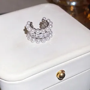Elegant silver-tone ear cuff with white pearls and sparkling square-cut cubic zirconia.
