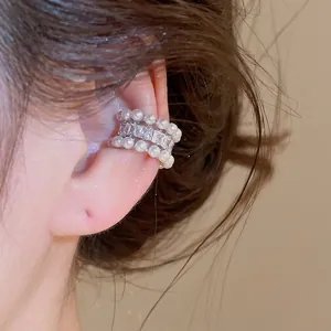 Elegant pearl and shiny zircon ear cuff for non-pierced ears shown on a model's ear