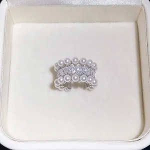 Elegant zircon and pearl ear cuff for non-pierced ears displayed in white jewelry box