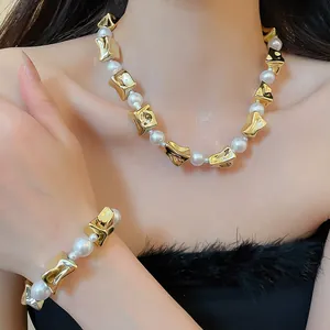 Close-up of irregular gold beads and white pearl necklace and bracelet jewelry set