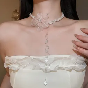 Close-up of elegant chiffon flower pearl choker with sparkling crystal drop pendant