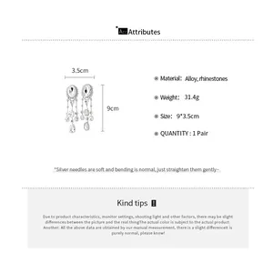 Detailed view of silver-toned rhinestone tassel earrings with product measurements
