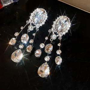 Detailed macro view of sparkling rhinestone oval teardrop tassel clip-on earrings