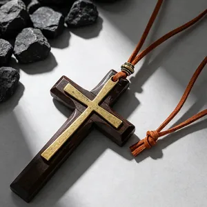 Close-up of vintage wooden cross pendant with gold metal inlay and textured bead