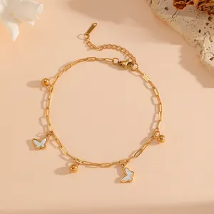 Detail view of 18K gold plated butterfly anklet with steel beads and paperclip chain.