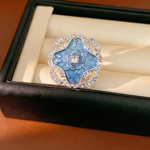 Vintage blue enamel floral open ring with sparkling rhinestone accents in a box