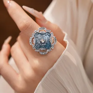 Macro detail of a vintage blue enamel flower ring with sparkling rhinestone accents