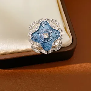 Macro view of vintage blue enamel flower ring with sparkling rhinestones and silver finish