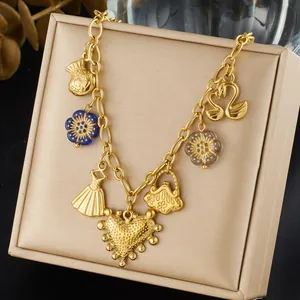 Macro view of a gold-plated vintage necklace featuring heart and flower charms