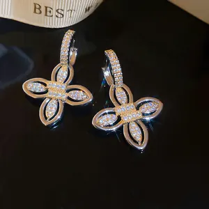 Detailed close-up of 18k gold-plated floral hoop earrings featuring sparkling zircons.