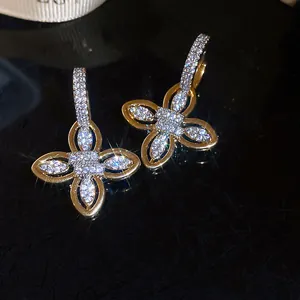 Exquisite close-up of 18k gold plated floral earrings featuring brilliant zircon stones