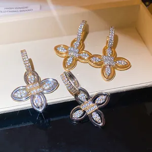 Detailed macro view of 18k gold plated flower earrings with sparkling zircons