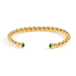 Elegant 18k gold plated twisted stainless steel cuff bracelet with green zircon stones.