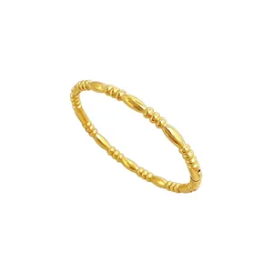 Elegant minimalist gold-plated stainless steel bangle with unique bamboo-style texture