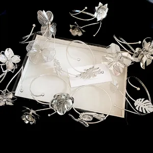 Exquisite silver metallic arm cuffs featuring detailed flower and leaf patterns in a set