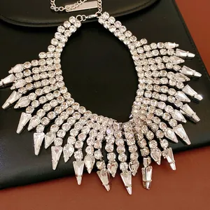 Close-up detail of luxurious silver fringe necklace with sparkling rhinestones and tassels