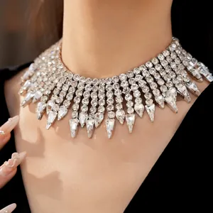 Close-up of exaggerated rhinestone tassel collar necklace with teardrop crystal pendants