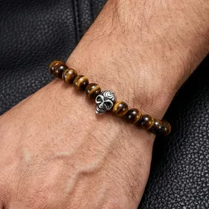 Men's tiger eye beaded bracelet with vintage silver skull on black leather wrist