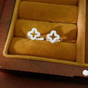 Detailed view of pavé-set zircon hollow clover earrings in a velvet jewelry box