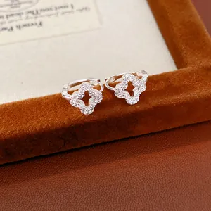 Close-up detail of elegant silver hollow clover hoop earrings with sparkling zircon stones