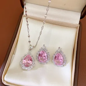 Close-up of an elegant pink teardrop necklace and earrings jewelry set in a display box