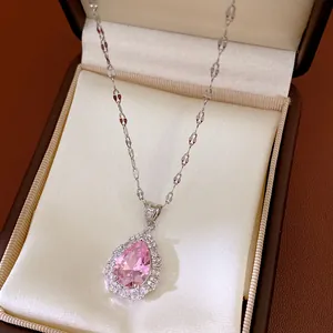Detail view of a royal style necklace with a pink pear-shaped zircon pendant in a box.