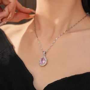 Elegant close-up shot of a vintage pear-shaped pink zircon necklace on a model's neck area