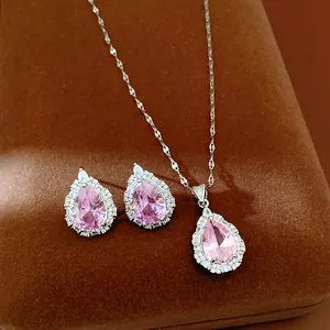 Close-up detail of elegant pink pear-cut crystal necklace and matching stud earrings jewelry set