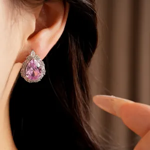 Close-up of elegant palace-style pear-shaped pink zircon earring on a model's ear