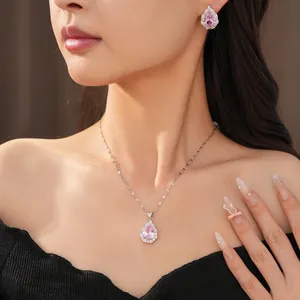 Detailed view of palace style jewelry set with pink teardrop zircon necklace and earrings.
