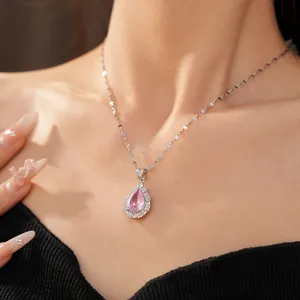 Close-up of elegant palace style silver necklace with pink waterdrop zircon pendant