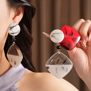 Elegant resin geometric drop earrings featuring a unique black and white ink marble pattern
