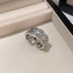 Close-up of luxury silver-tone open ring with sparkling zircon lace-edge design