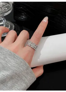 Close-up detail of a silver zircon lace ring worn on a finger in an elegant style