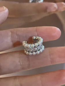 Close-up macro shot of an elegant vintage pearl and zircon encrusted C-shaped ear cuff earring