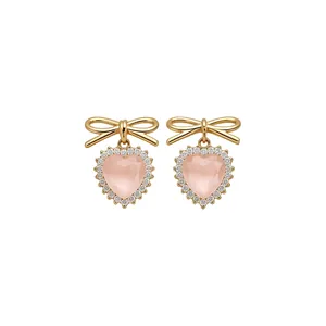 Elegant bow stud earrings with pink heart cat's eye stone and zircon pavé accents