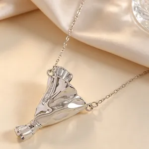 Dettaglio macro del ciondolo a sacchetto d'argento con design plissettato su catenina