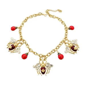 Elegant gold-tone link chain necklace with crystal bees and enamel ladybug charms