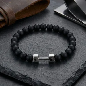 Macro detail of black onyx beads and silver dumbbell charm with LIFE and FIT engraving