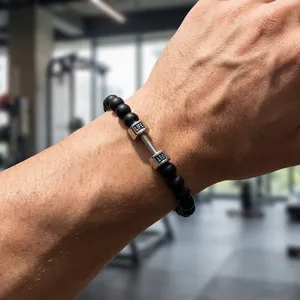 Detail of beaded fitness bracelet with matte black stones and barbell LIFE FIT engraving