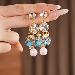 Detailed view of luxury vintage tassel earrings with square crystals and white pearls