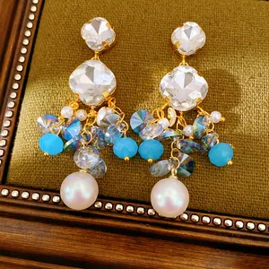 Close-up of vintage geometric square glass fringe earrings with white pearl tassels